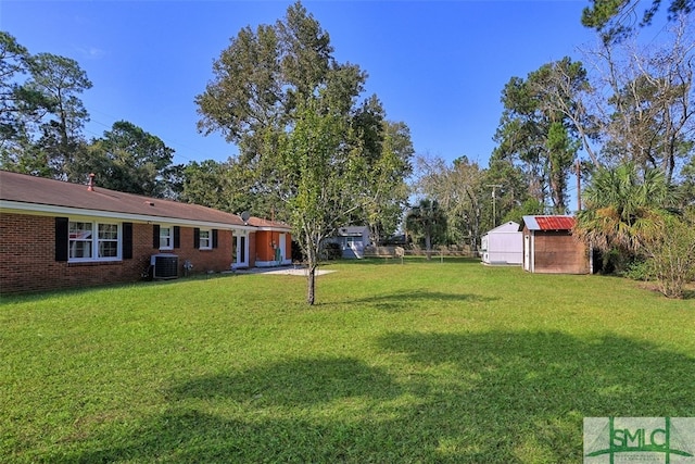 view of yard with an outdoor structure and central air condition unit