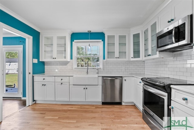 kitchen featuring white cabinets, appliances with stainless steel finishes, and sink