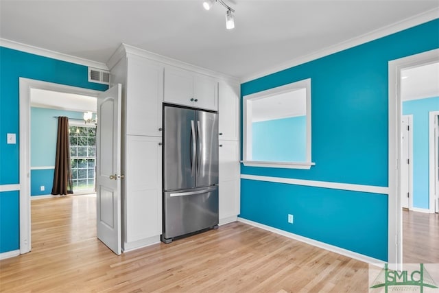 kitchen with stainless steel fridge, light hardwood / wood-style floors, crown molding, and white cabinetry