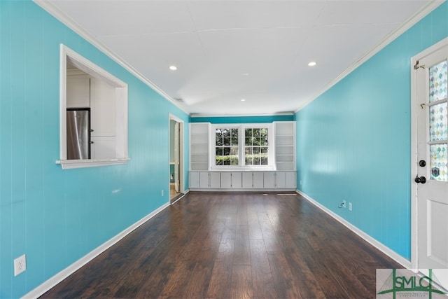 spare room featuring ornamental molding, hardwood / wood-style floors, and a healthy amount of sunlight