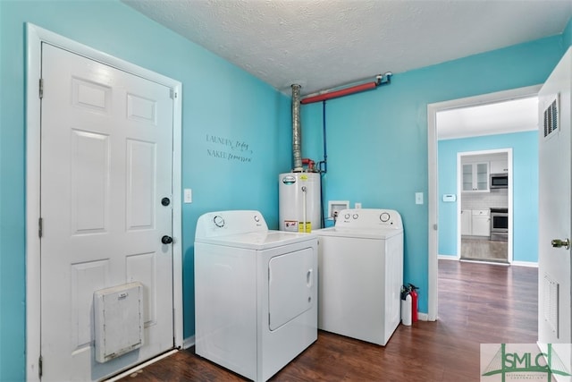 laundry room with gas water heater, independent washer and dryer, dark hardwood / wood-style floors, and a textured ceiling