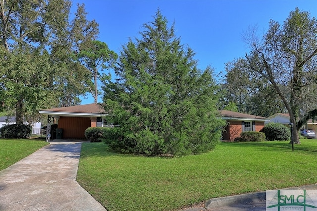 view of front of house with a front yard and a carport