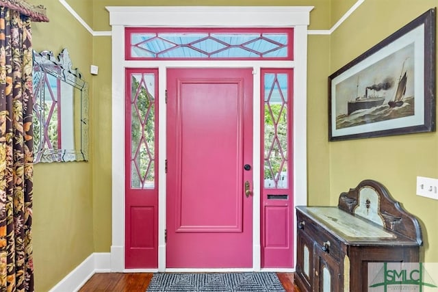 entryway featuring dark hardwood / wood-style floors and crown molding