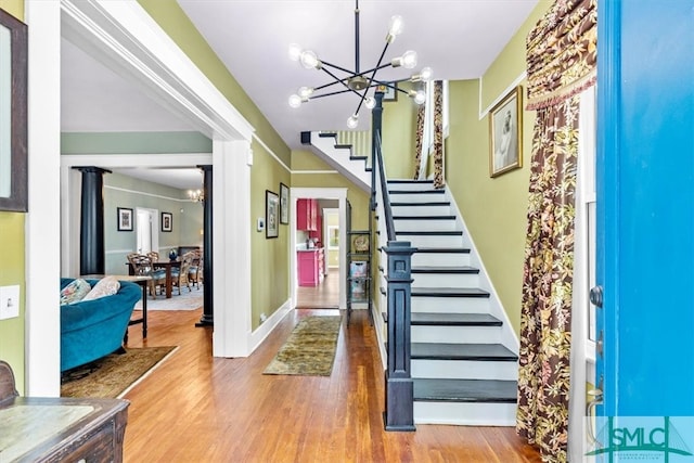 entrance foyer featuring wood-type flooring and a notable chandelier