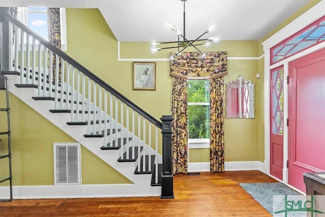 foyer entrance featuring an inviting chandelier and hardwood / wood-style floors