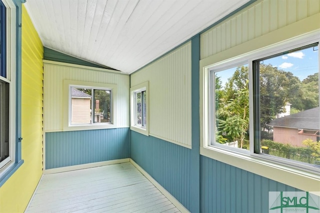 unfurnished sunroom featuring wooden ceiling, lofted ceiling, and a wealth of natural light