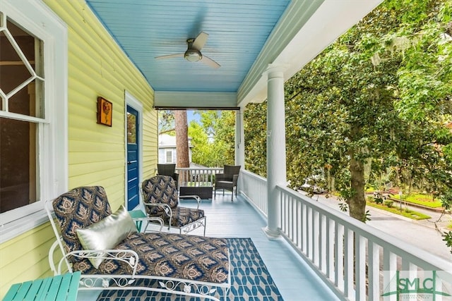 balcony with ceiling fan and a porch