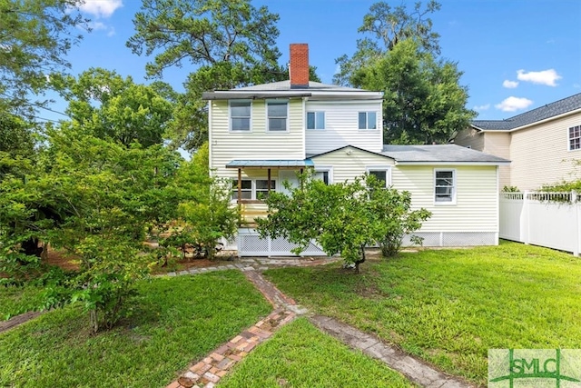 back of house with a yard