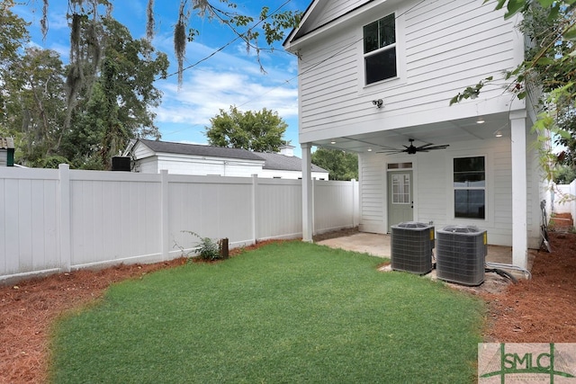 view of yard featuring central AC unit and ceiling fan