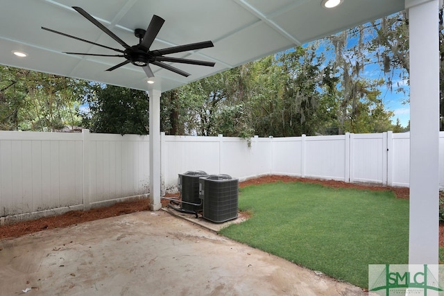 view of yard with ceiling fan, cooling unit, and a patio area