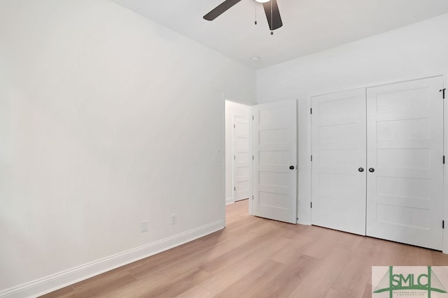 unfurnished bedroom featuring ceiling fan, light hardwood / wood-style flooring, and a closet