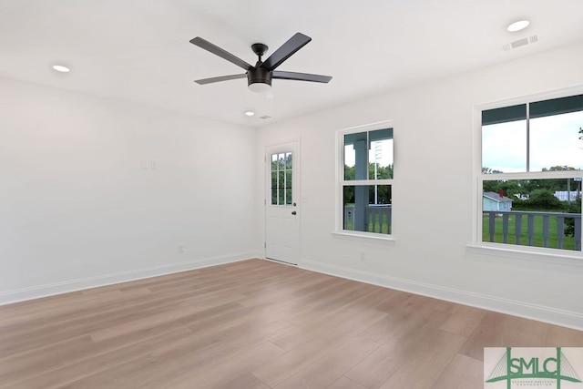 empty room featuring ceiling fan and light hardwood / wood-style floors