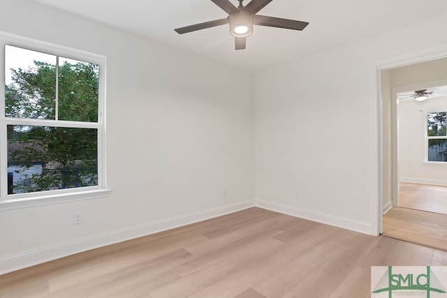 unfurnished room featuring ceiling fan, light wood-type flooring, and a wealth of natural light