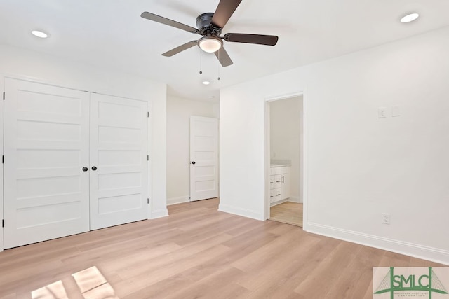 unfurnished bedroom featuring ceiling fan, light hardwood / wood-style flooring, connected bathroom, and a closet