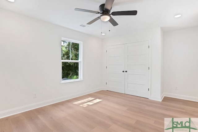 unfurnished bedroom featuring ceiling fan, a closet, and light hardwood / wood-style flooring