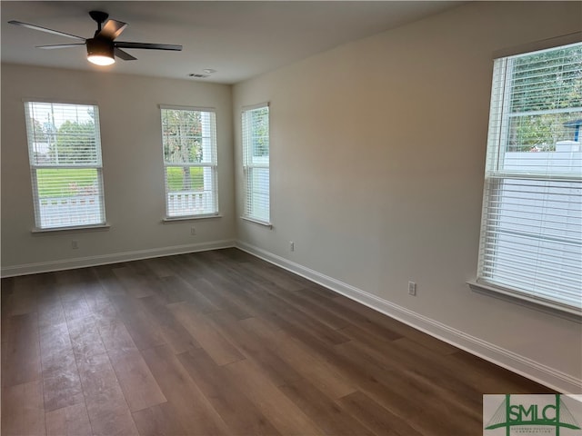 spare room featuring ceiling fan and dark hardwood / wood-style flooring