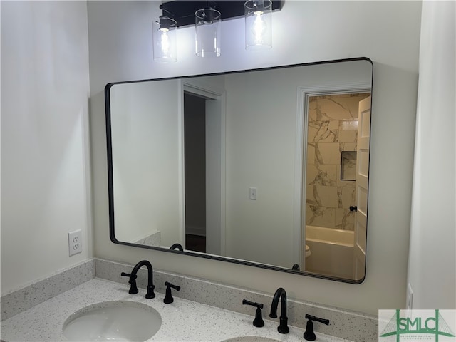 full bathroom featuring tiled shower / bath combo, vanity, and toilet