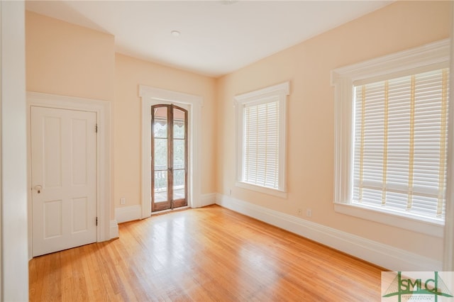 spare room featuring light hardwood / wood-style floors and a wealth of natural light