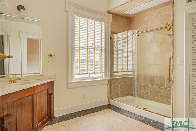 bathroom featuring an enclosed shower, vanity, tile patterned floors, and a wealth of natural light