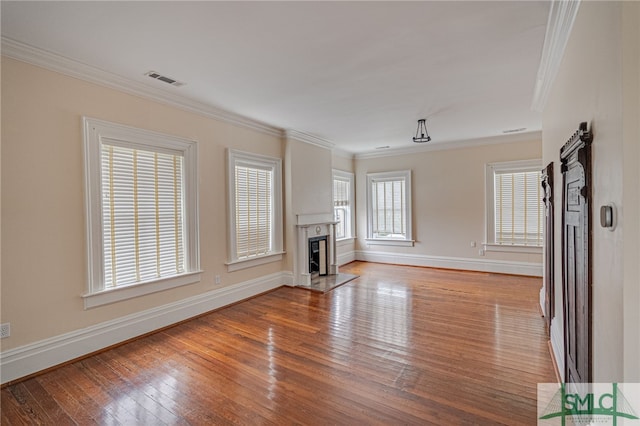 unfurnished living room featuring crown molding, light hardwood / wood-style floors, and a high end fireplace