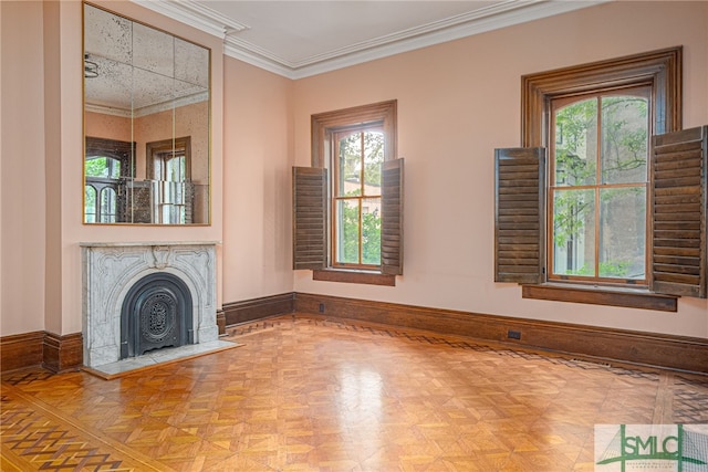 unfurnished living room with ornamental molding, parquet floors, and a healthy amount of sunlight