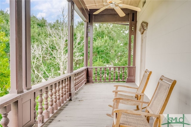 wooden terrace featuring ceiling fan and covered porch