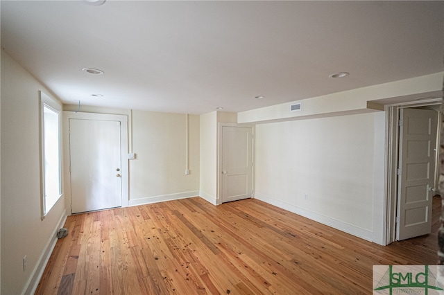 spare room with light hardwood / wood-style flooring