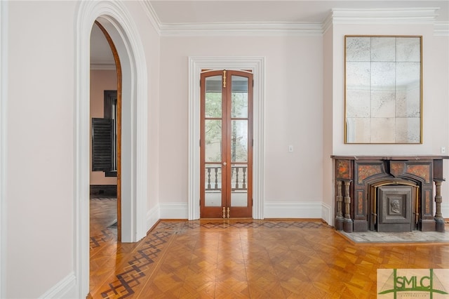 entryway with ornamental molding, parquet floors, and a wood stove