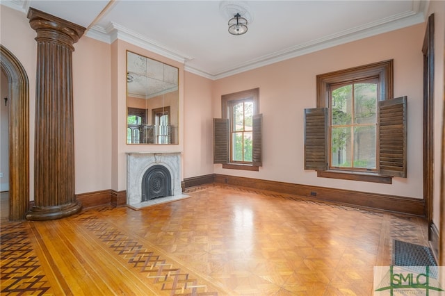 unfurnished living room with ornamental molding, a wealth of natural light, decorative columns, and parquet floors