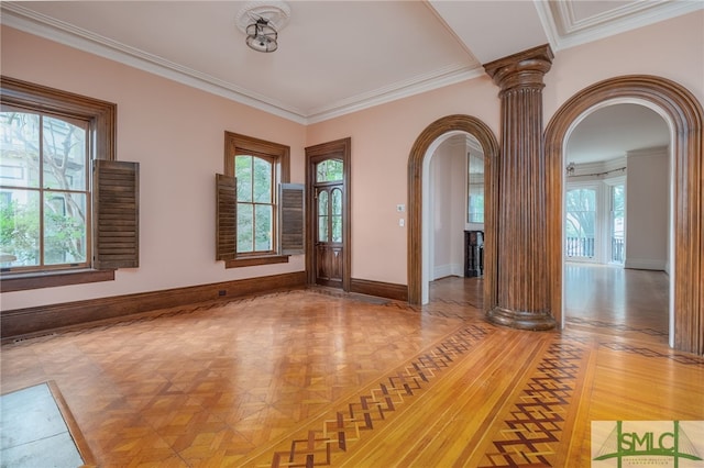 spare room featuring ornamental molding, parquet flooring, and ornate columns