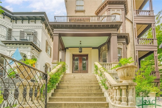 entrance to property featuring french doors and a balcony