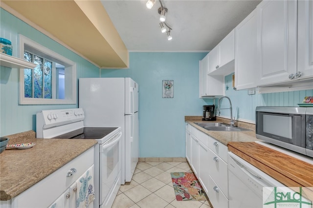 kitchen with white cabinets, light tile patterned floors, sink, white appliances, and rail lighting