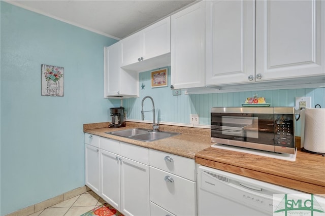 kitchen featuring dishwasher, white cabinetry, and sink