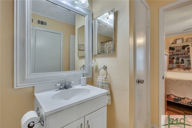 bathroom featuring a textured ceiling and vanity