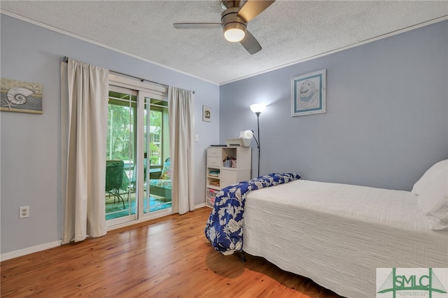 bedroom featuring a textured ceiling, ceiling fan, access to outside, ornamental molding, and hardwood / wood-style floors