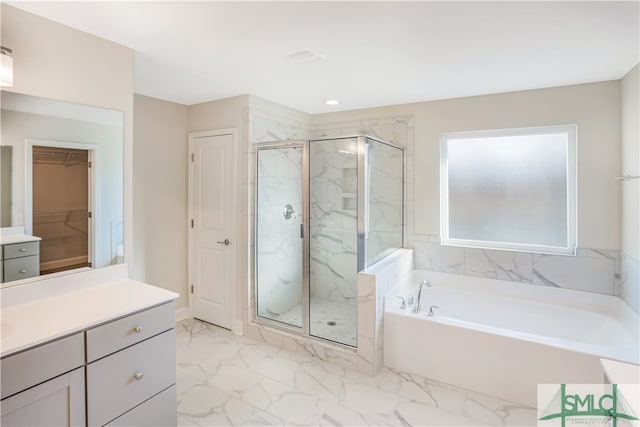 bathroom featuring plus walk in shower and vanity