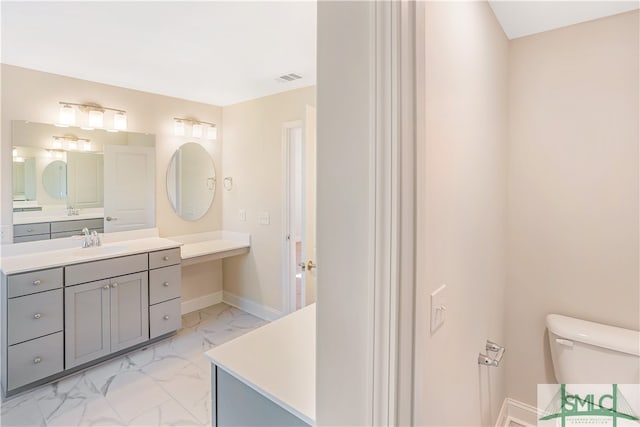 bathroom featuring vanity and toilet