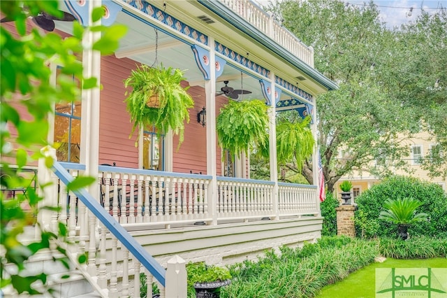 view of side of home featuring covered porch