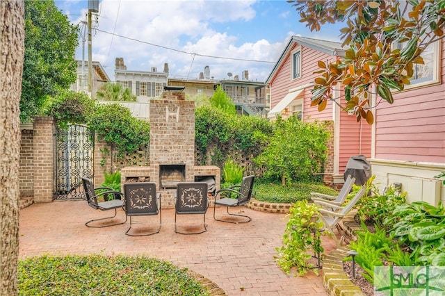 view of patio / terrace with an outdoor brick fireplace