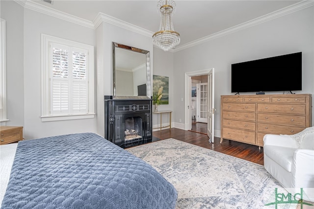 bedroom with ornamental molding, dark hardwood / wood-style floors, and a notable chandelier