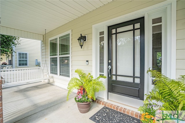 doorway to property featuring a porch