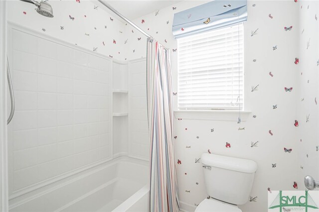 bathroom with shower / tub combo and toilet