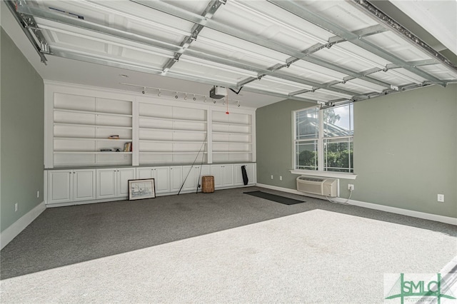 garage featuring a garage door opener and an AC wall unit