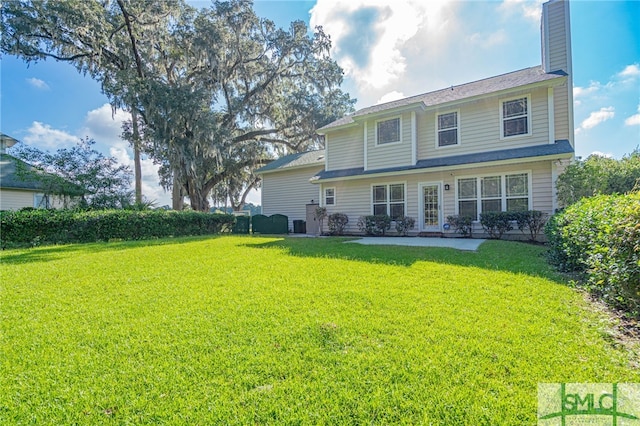 rear view of property with a lawn