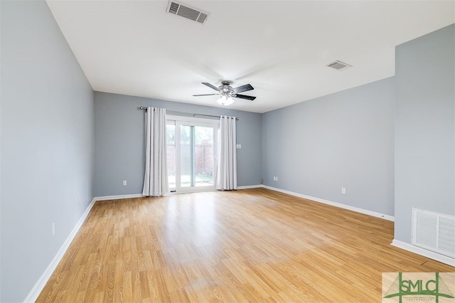 spare room with light wood-type flooring and ceiling fan