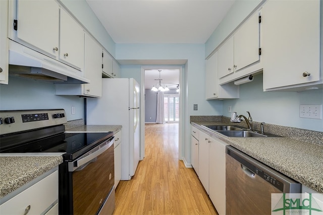 kitchen featuring a notable chandelier, stainless steel appliances, white cabinets, and light wood-type flooring