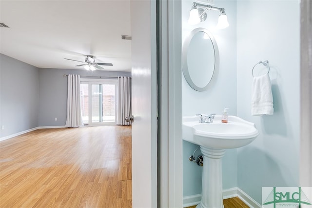 bathroom featuring ceiling fan and hardwood / wood-style flooring