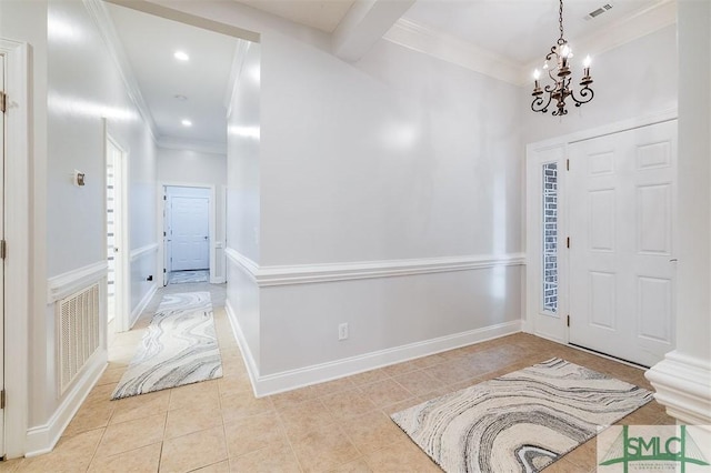 entryway with ornamental molding, visible vents, baseboards, and light tile patterned floors