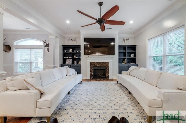 living room featuring crown molding and ceiling fan