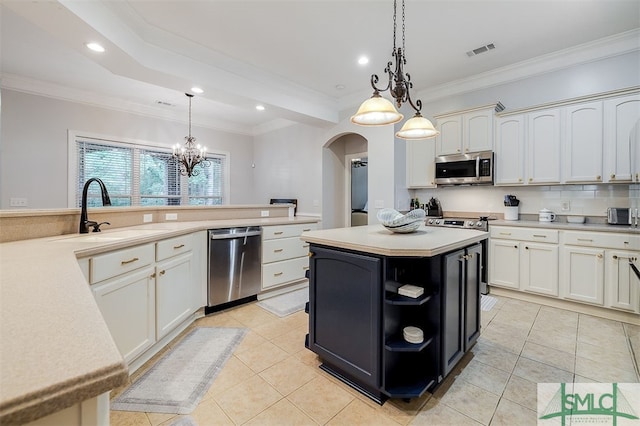 kitchen featuring appliances with stainless steel finishes, light countertops, a sink, and visible vents